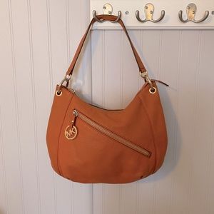 Gently used Michael Kors orange leather handbag.